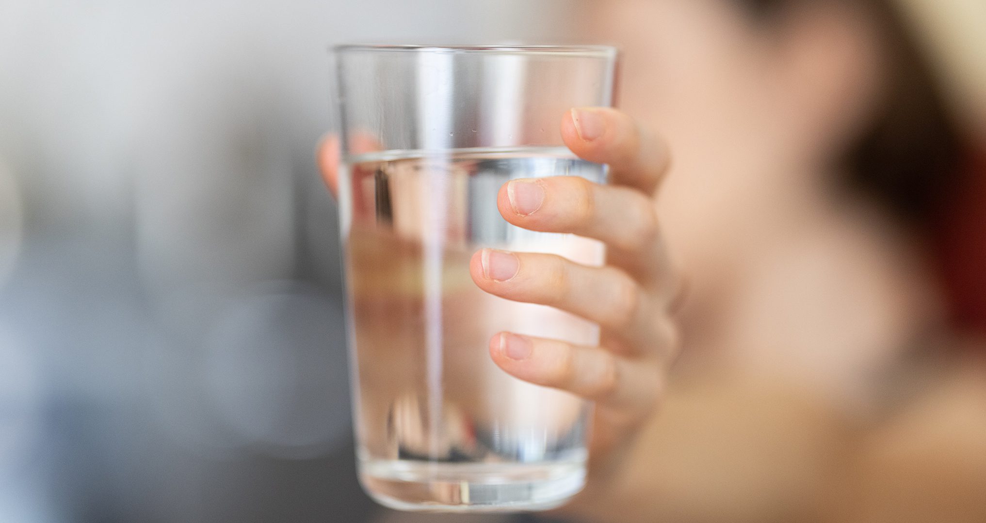 woman holding a fresh glass of water